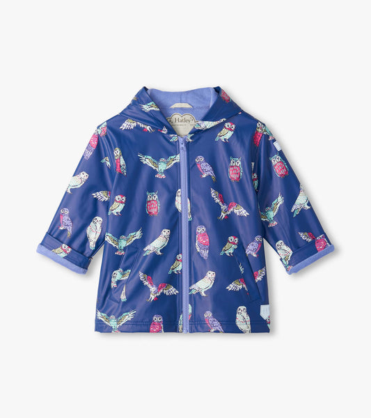 Front view of kids' blue hooded rain coat with colorful owl print, zip front, patch pockets, and rolled cuffs