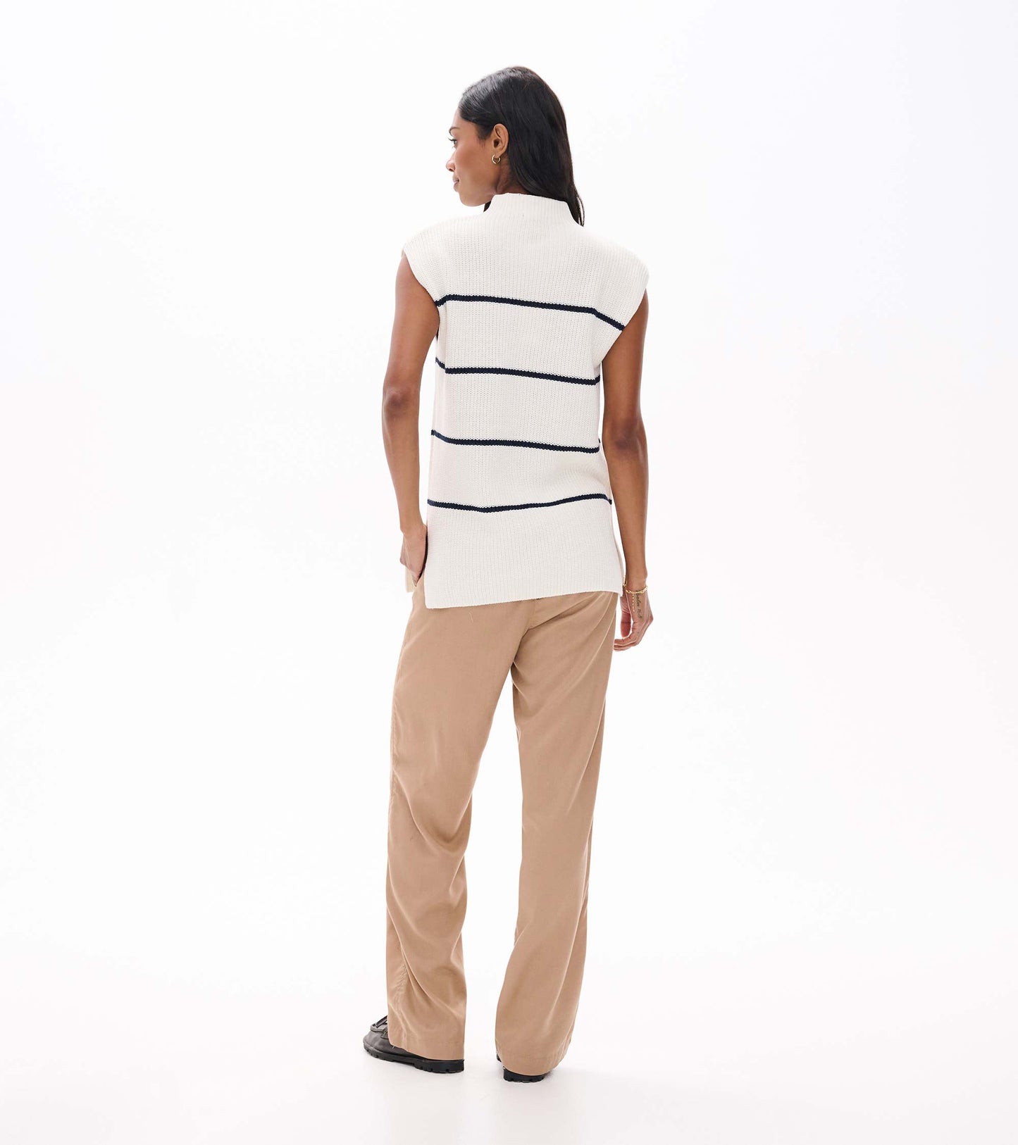Back view of cream sleeveless sweater tunic with navy horizontal stripes and mock neck