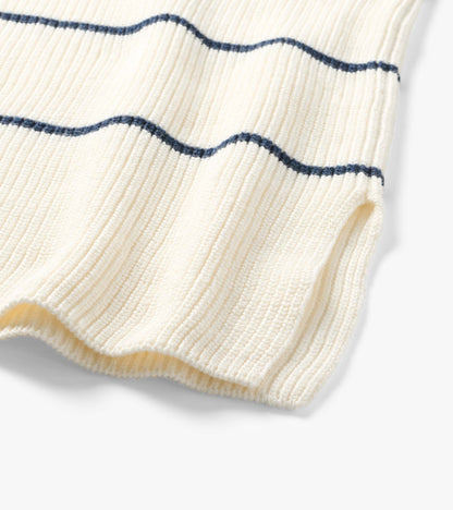 Close-up of cream ribbed knit tunic hem with thin navy horizontal stripes
