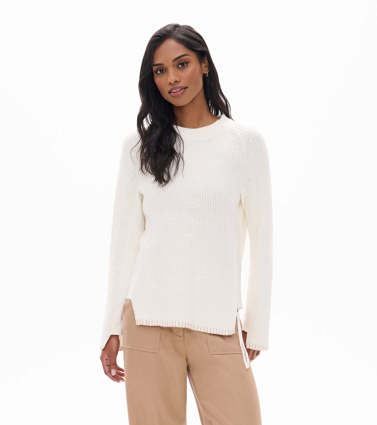 Cream raglan sweater with ribbed crew neck and side zip details, shown on model from the front