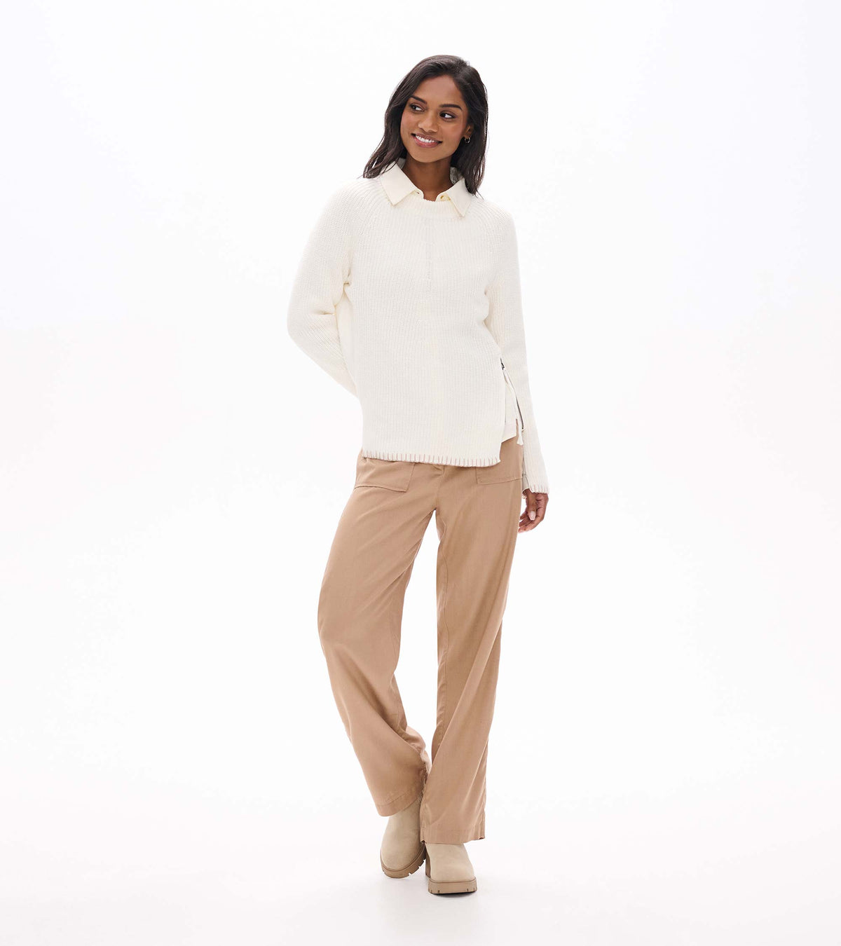 Cream raglan sweater styled over a collared shirt, front view with side zip detail visible