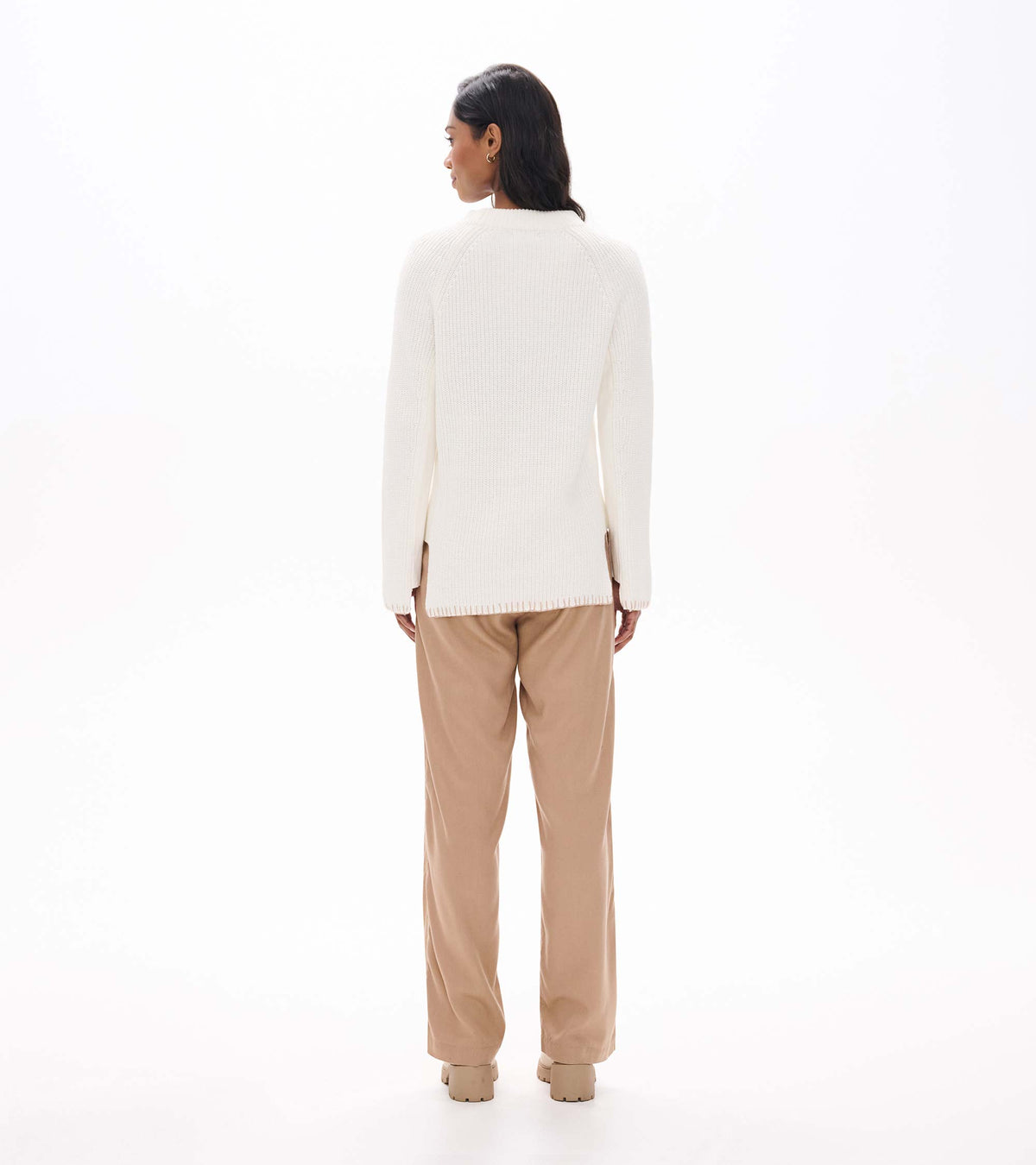 Back view of cream raglan sweater with side zips at the hem and a straight, longer silhouette