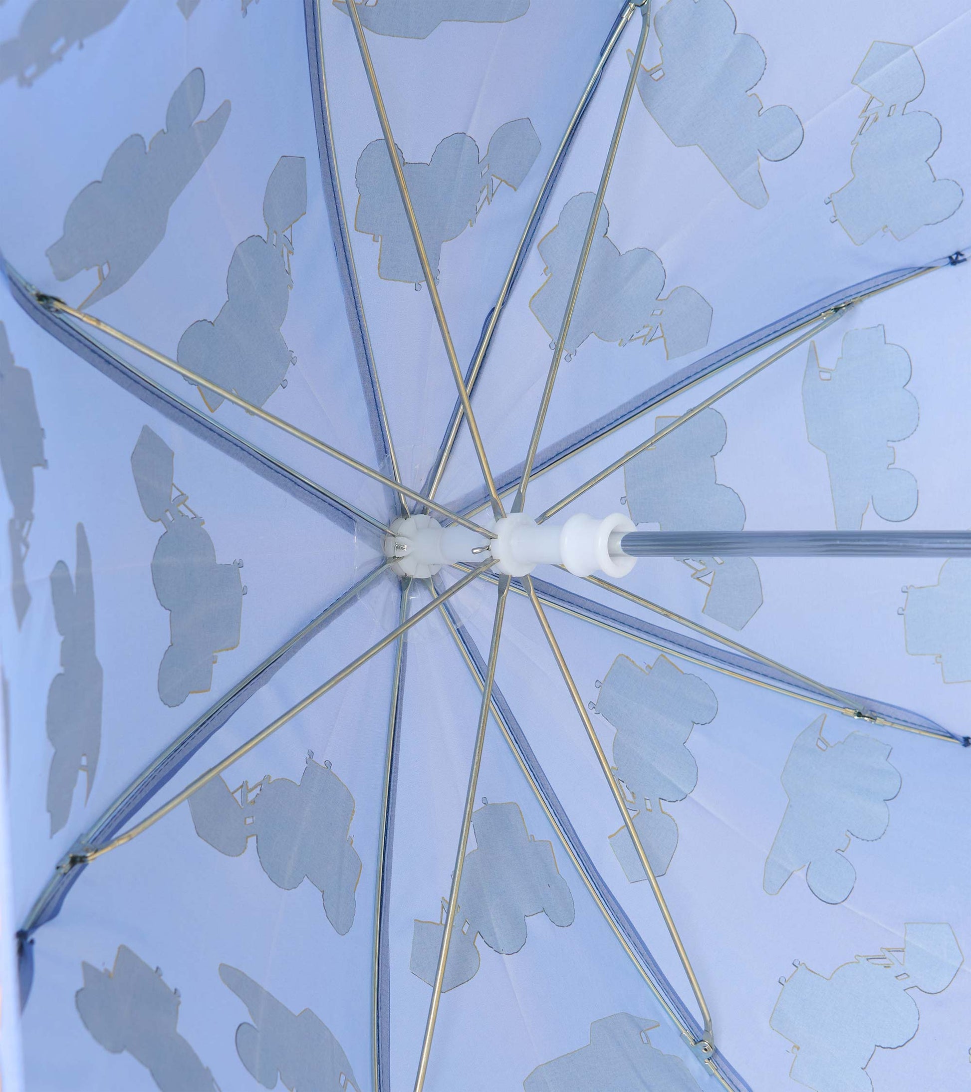 Underside of blue umbrella showing metal ribs and pale construction vehicle silhouettes