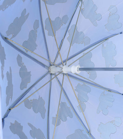 Underside of blue umbrella showing metal ribs and pale construction vehicle silhouettes