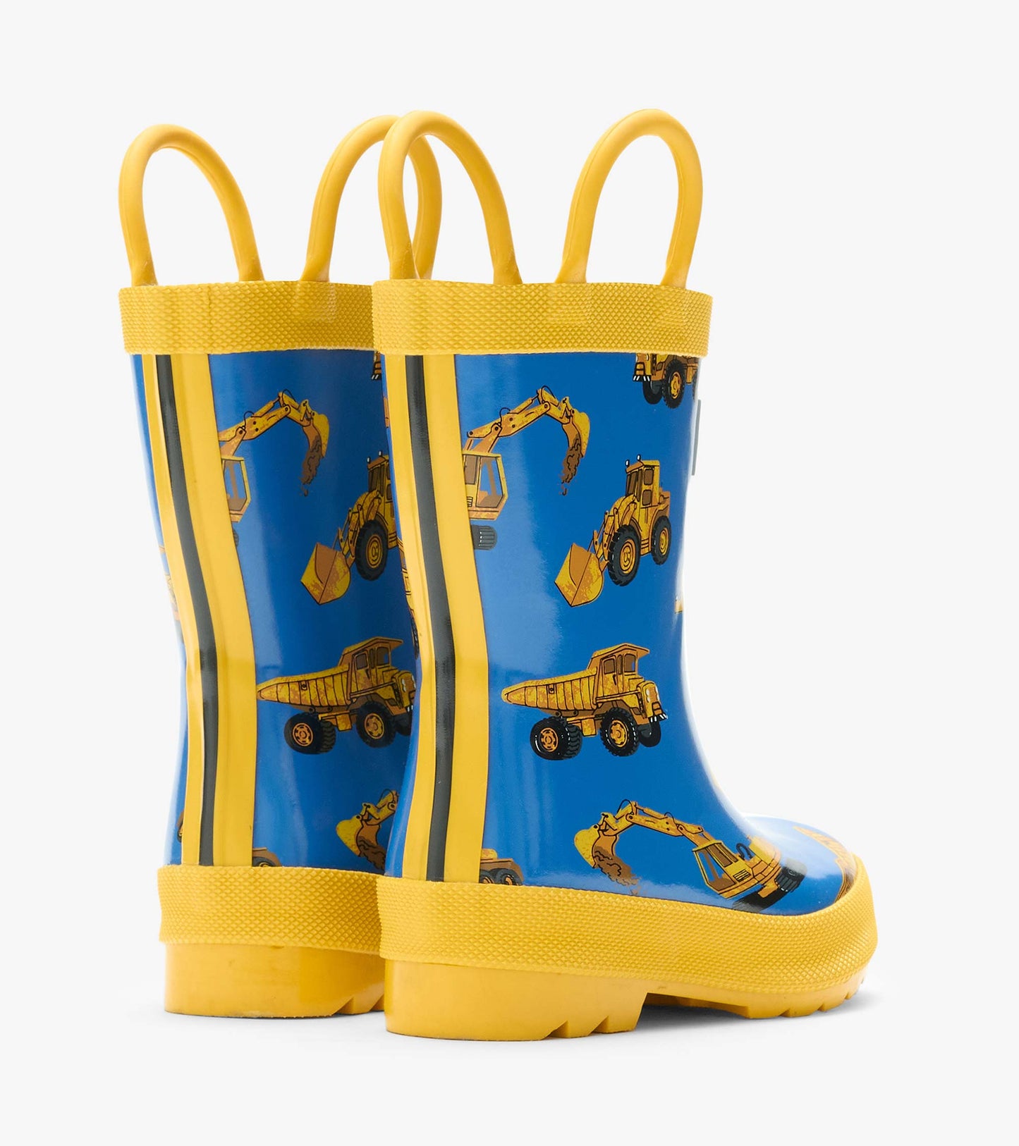 Back angled view of blue rain boots with yellow handles and construction truck print
