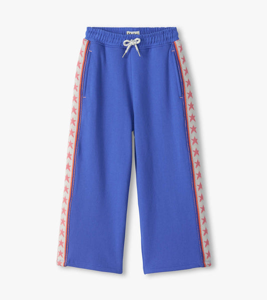 Blue wide leg track pants with drawstring waist and pink star side stripes