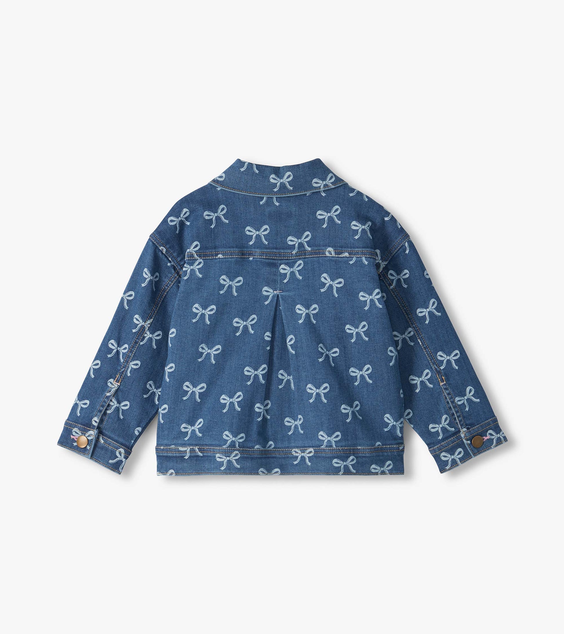 Back view of blue slouchy denim jacket with allover white bow print and pleated back detail