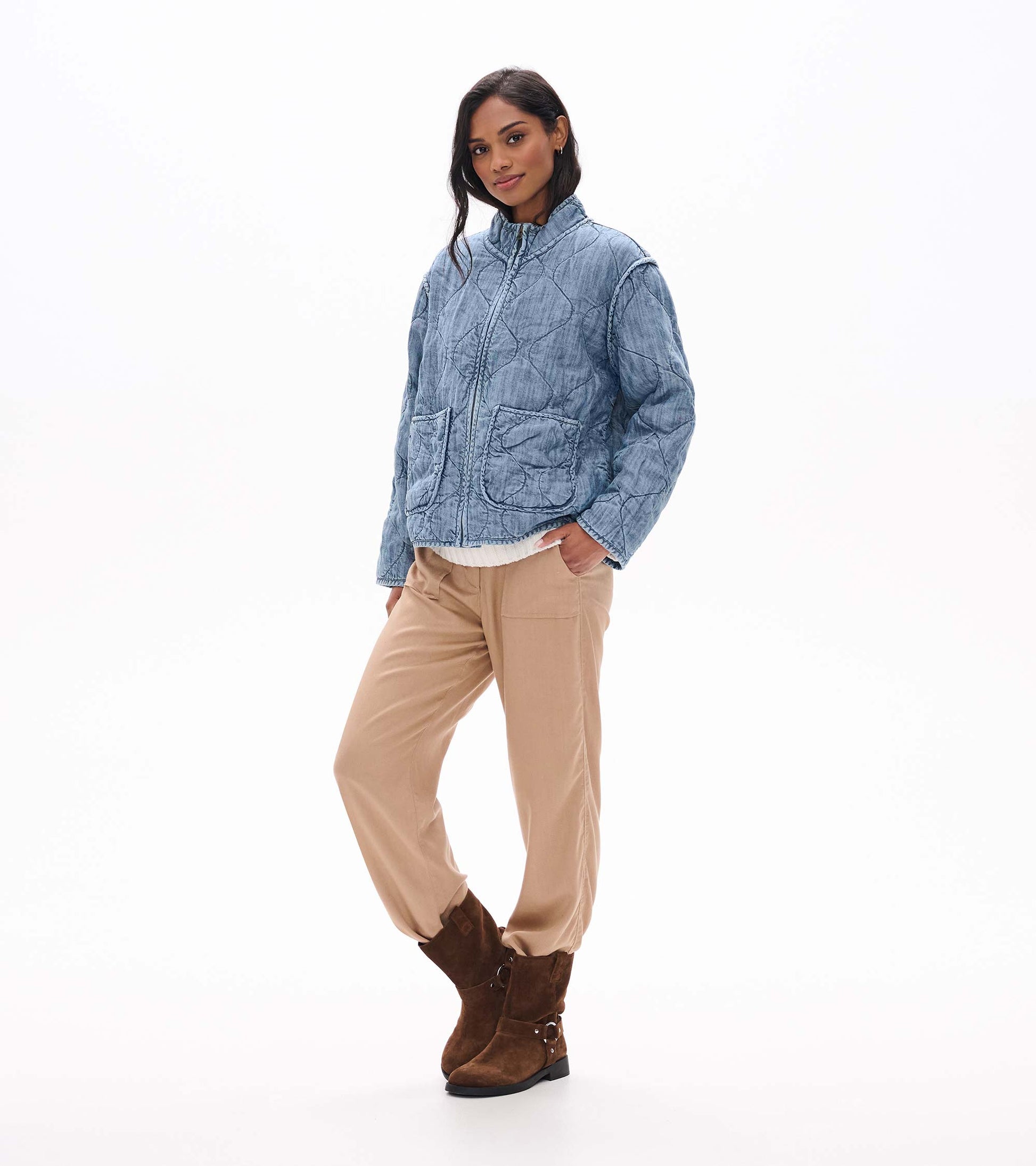 Front three-quarter view of blue acid rinse quilted jacket with stand collar and oversized patch pockets