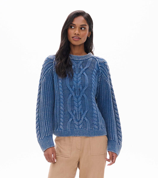 Model wearing stellar blue cable knit sweater with ribbed crew neck and long sleeves