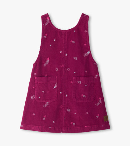 Front view of magenta pinafore dress with embroidered stars, scoop neck, and two front patch pockets