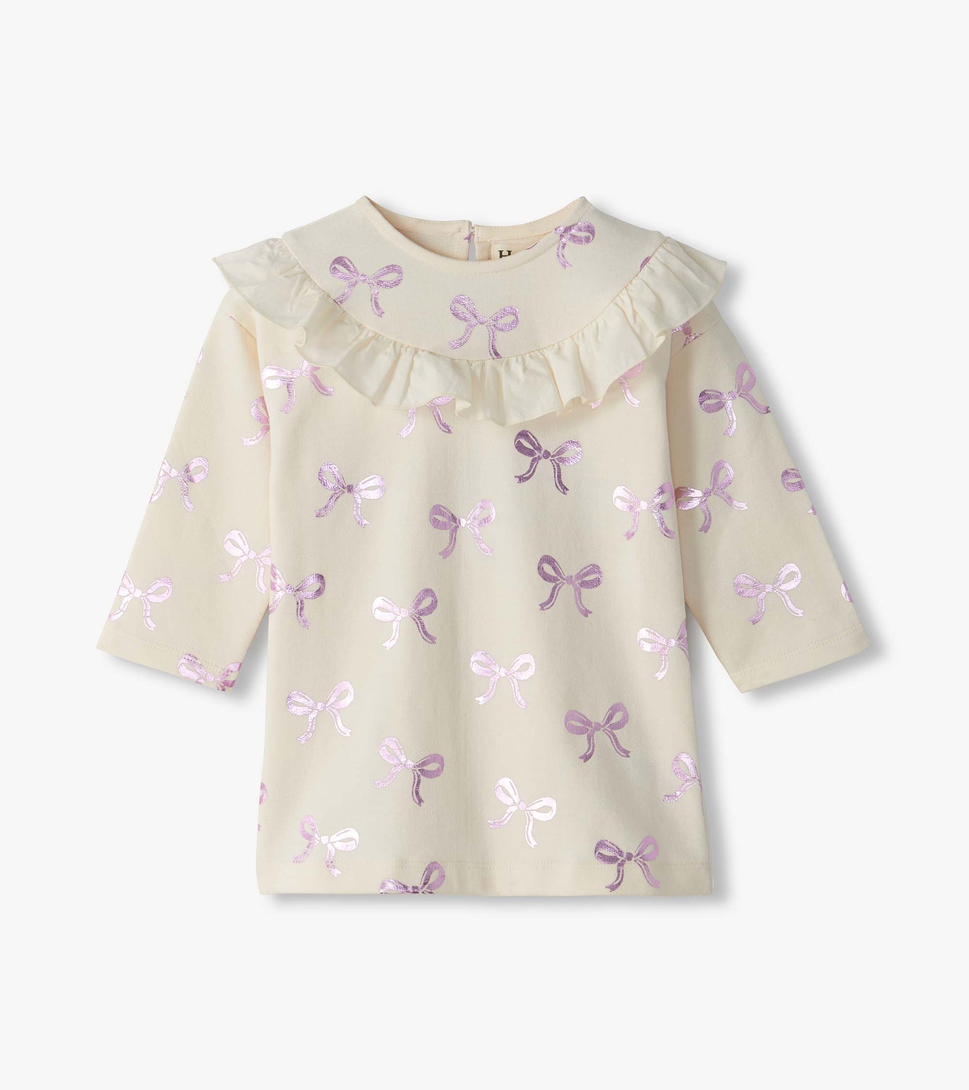 Front view of infant cream ruffle dress with long sleeves and pink foil bow print
