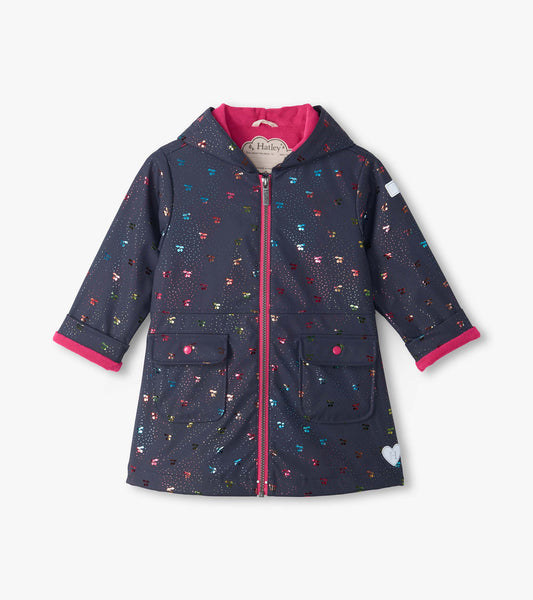 Front view of navy hooded rain coat with rainbow foil cherry print, pink lining, zipper, and two flap pockets