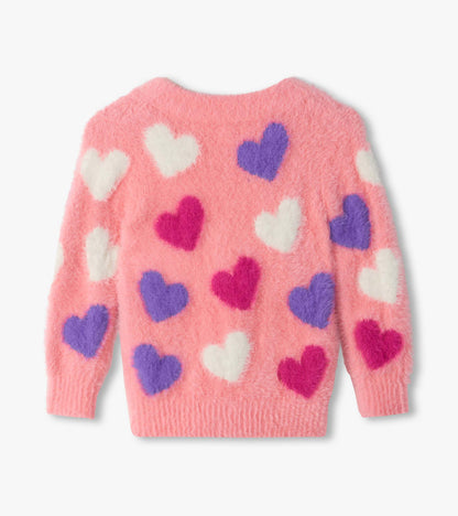 Back view of pink fuzzy cardigan with white, purple, and bright pink heart pattern