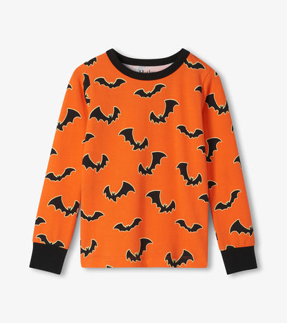 Orange long sleeve pajama top with black bat print and black neck and sleeve cuffs