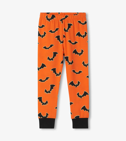 Orange pajama pants with black bat print, elastic waistband, and black ankle cuffs