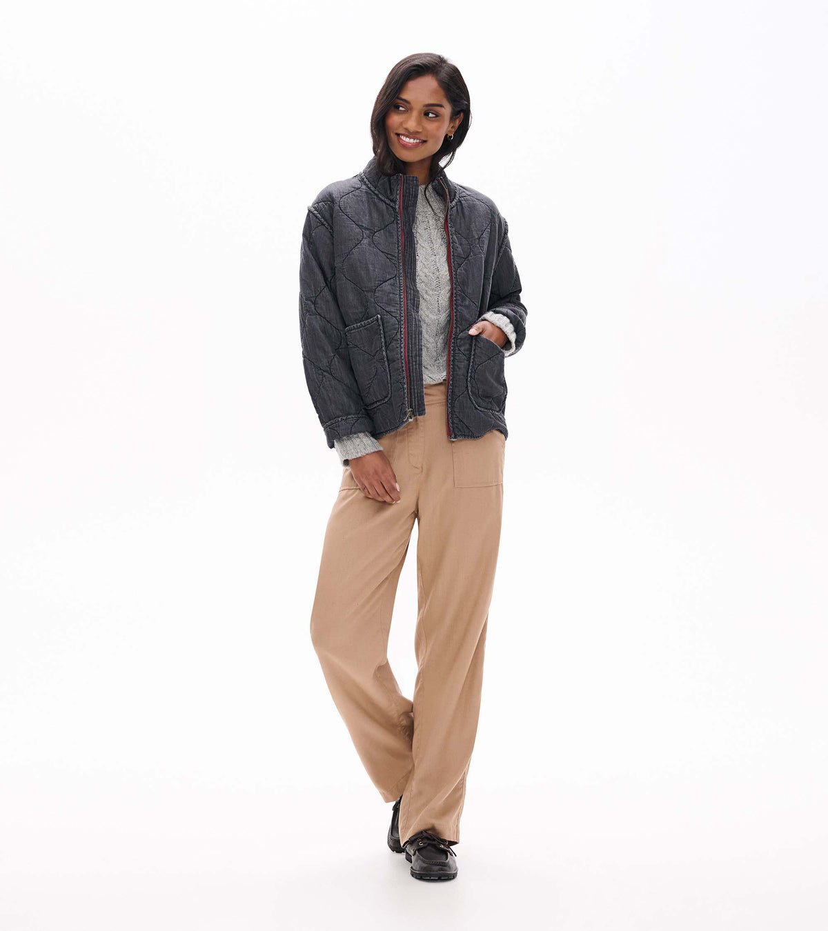 Women's washed black quilted jacket with a stand collar, patch pockets, and burgundy zip trim