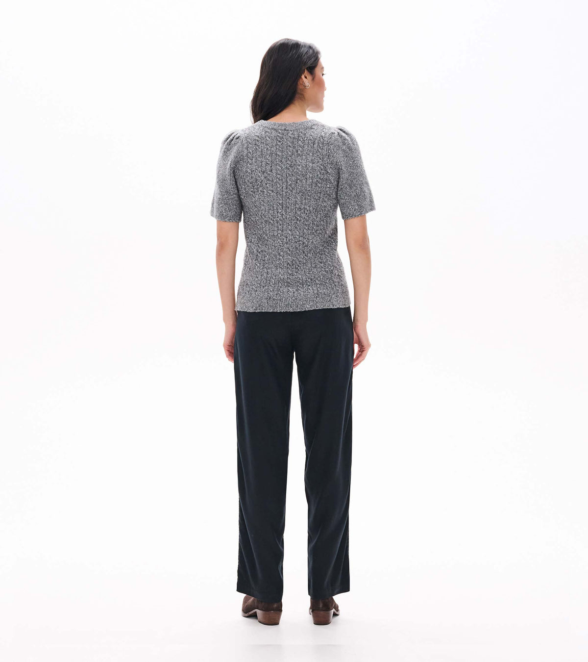 Back view of grey boucle sweater with short puff sleeves and a fitted shape