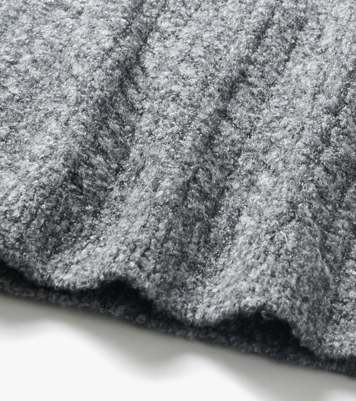 Close-up of the Emerson Sweater in grey boucle with a soft, nubby textured knit