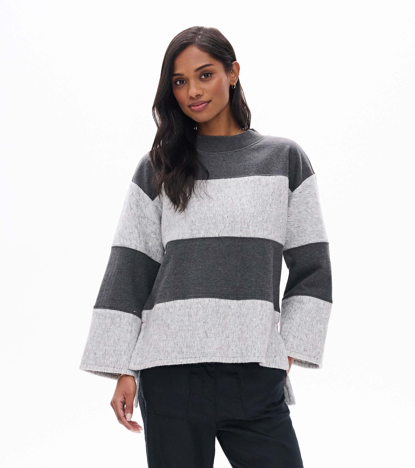 Front view of charcoal and light gray striped long sleeve top with a mock neck and wide sleeves
