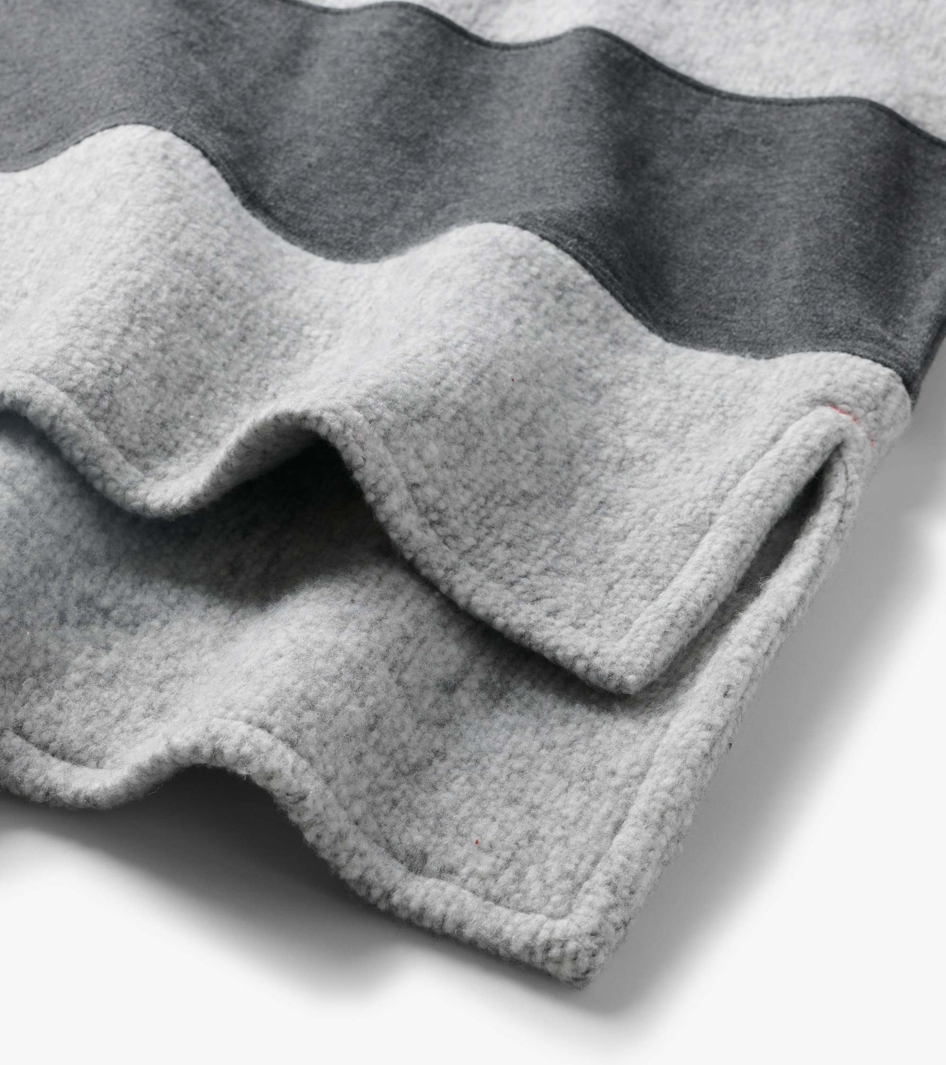 Close-up of the top showing charcoal and light gray stripes and a textured surface