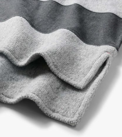 Close-up of the top showing charcoal and light gray stripes and a textured surface