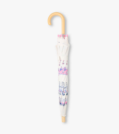 Closed clear umbrella with dog print, pink safety tips, and curved wooden-look handle