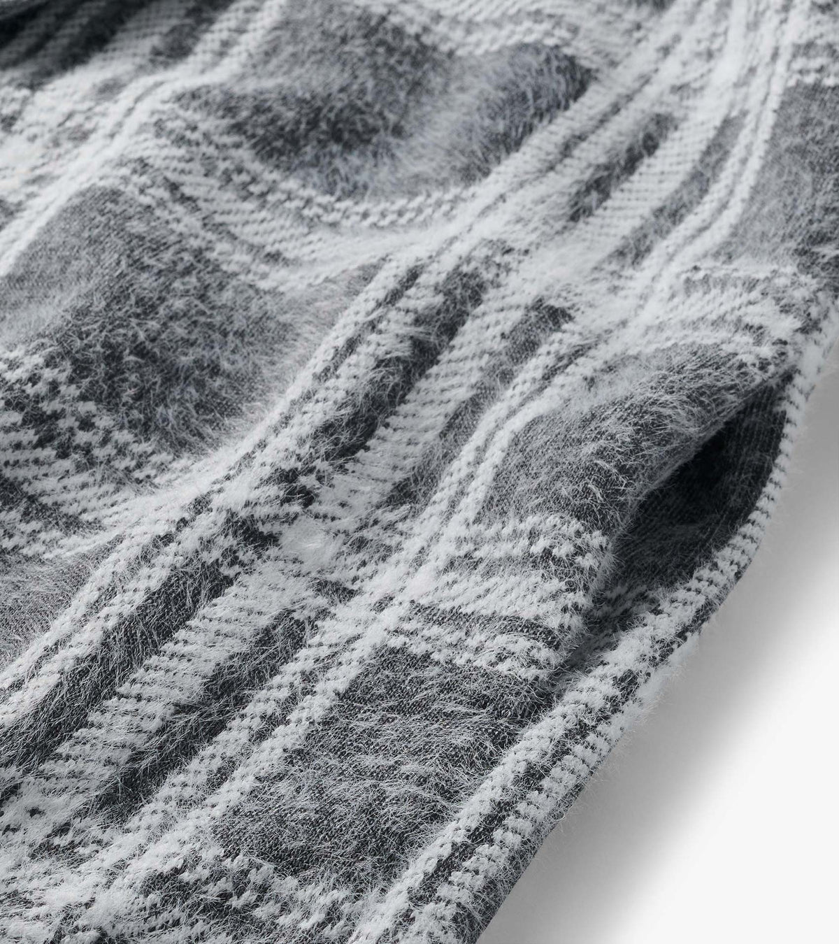 Close-up of charcoal and white plaid fabric with a soft brushed texture