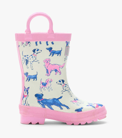 Side view of a cream rain boot with pink handles and trim, featuring blue and pink dog illustrations