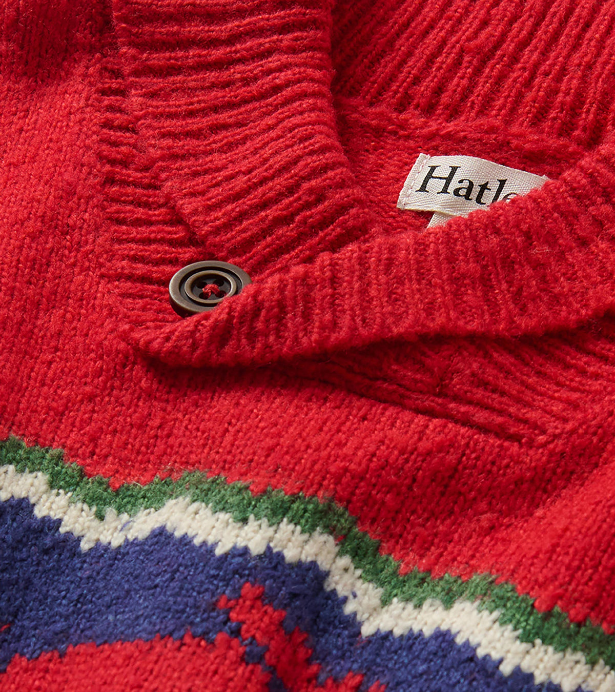 Close-up of ribbed red shawl collar with button and knit moose pattern detail
