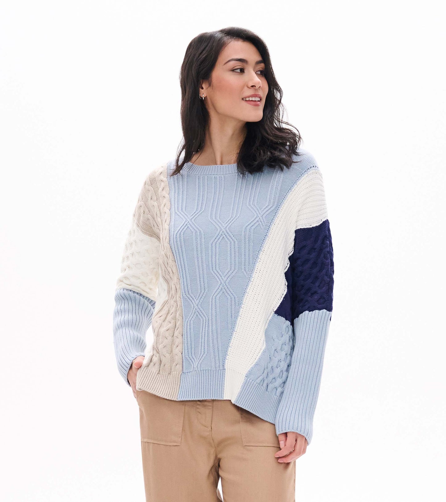 Front view of blue mixed-pattern sweater with cream, beige and navy textured panels