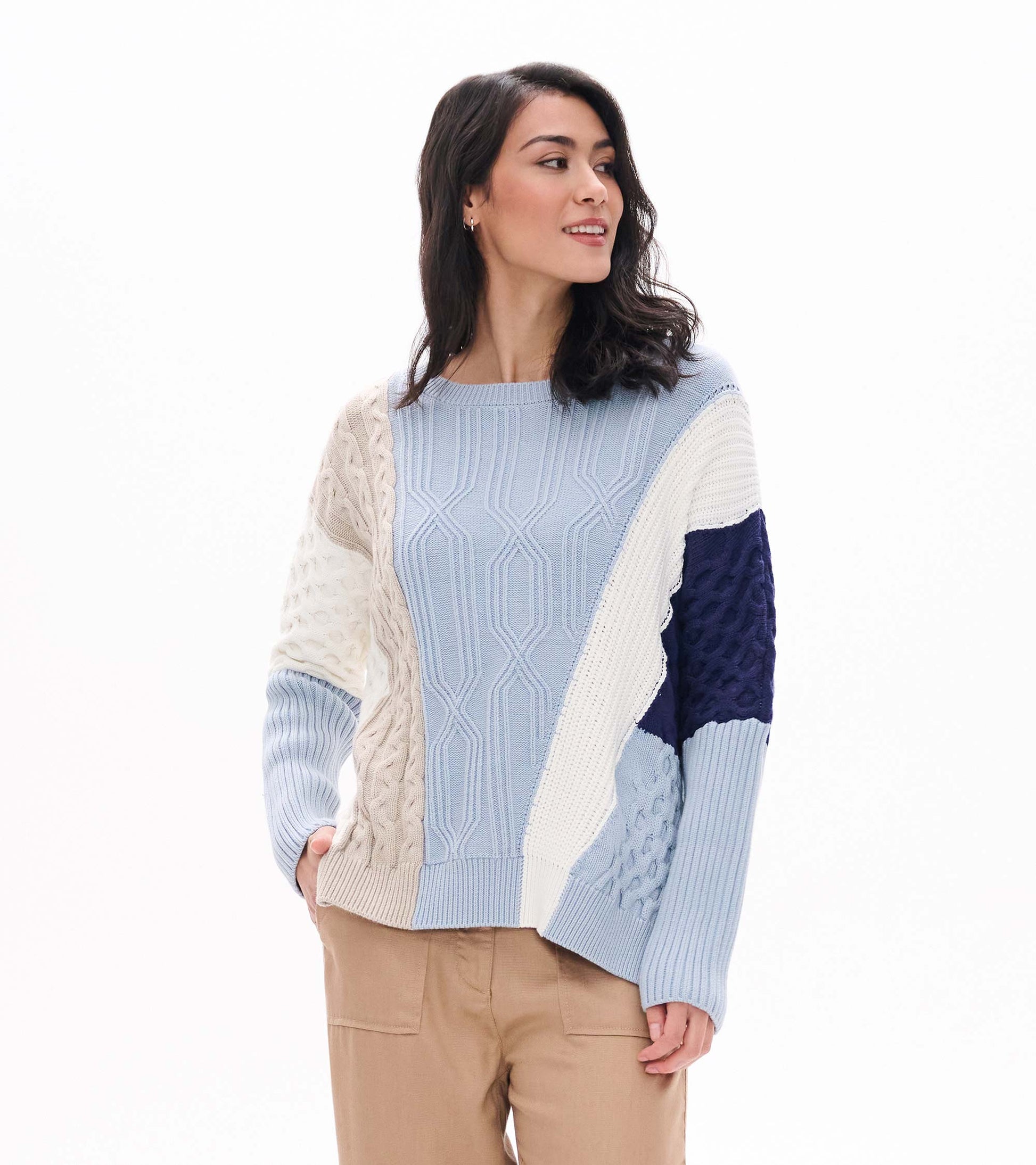 Front view of blue mixed-pattern sweater with cream, beige and navy textured panels