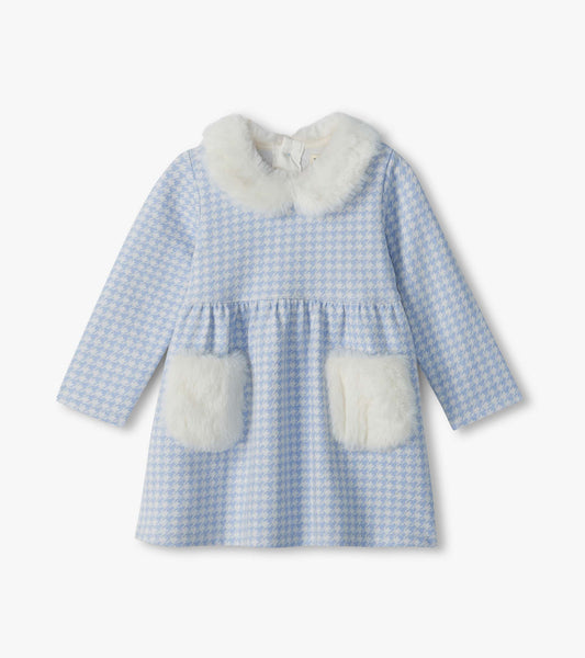 Infant blue and white houndstooth dress with long sleeves, white faux fur collar, and front patch pockets