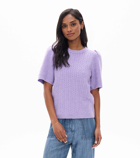 Model wearing lilac cable knit sweater with short puff sleeves, front view