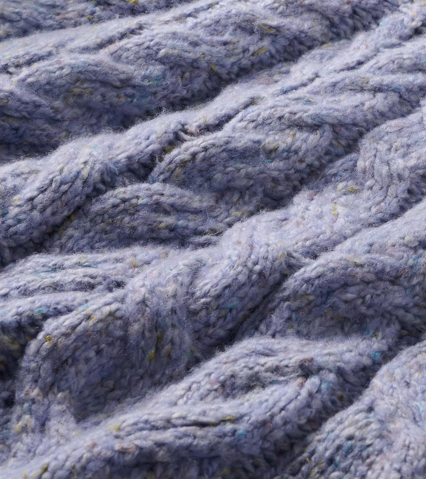 Close-up of the speckle lilac cable-knit sweater texture with multicolor flecks
