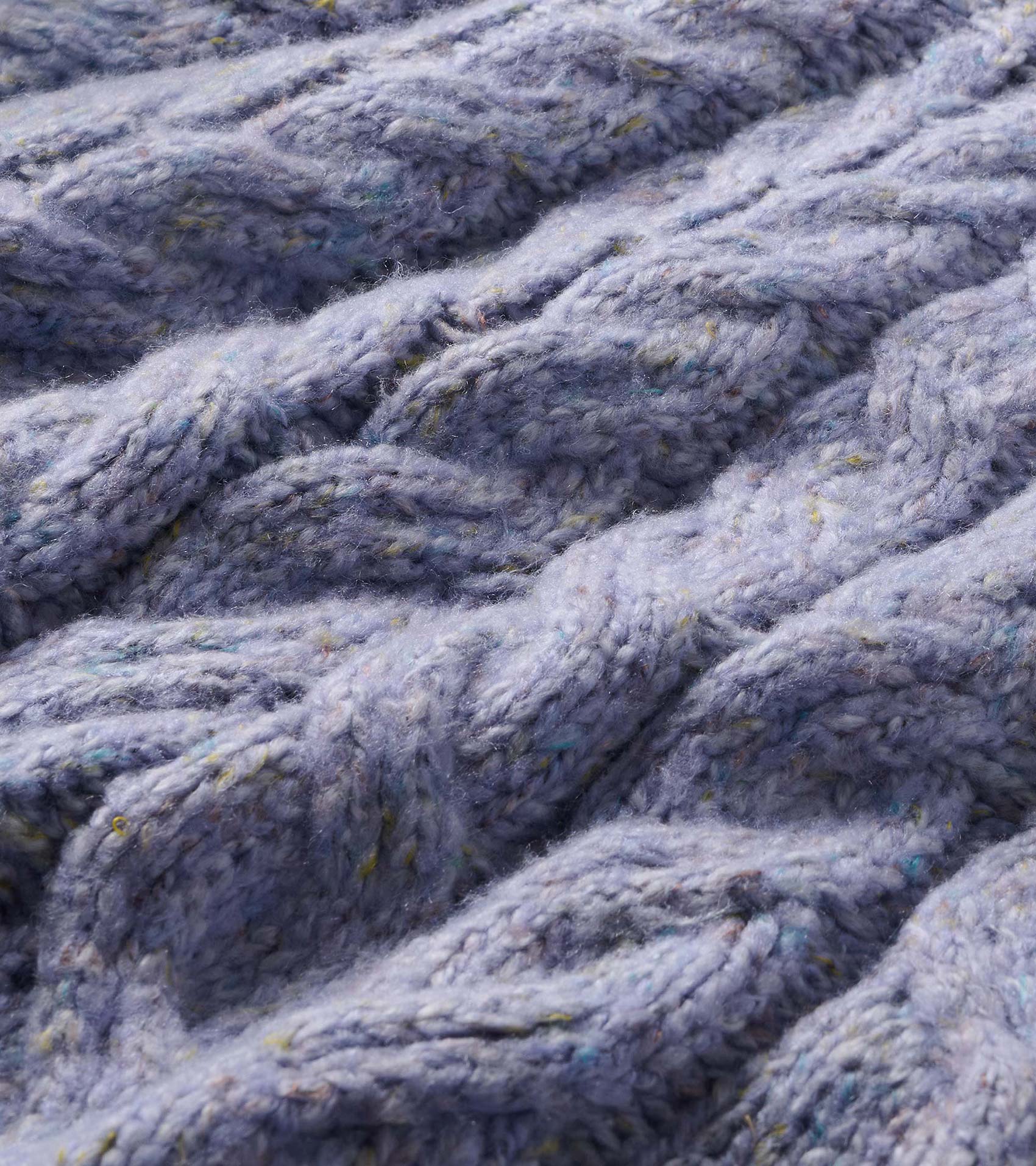 Close-up of the speckle lilac cable-knit sweater texture with multicolor flecks