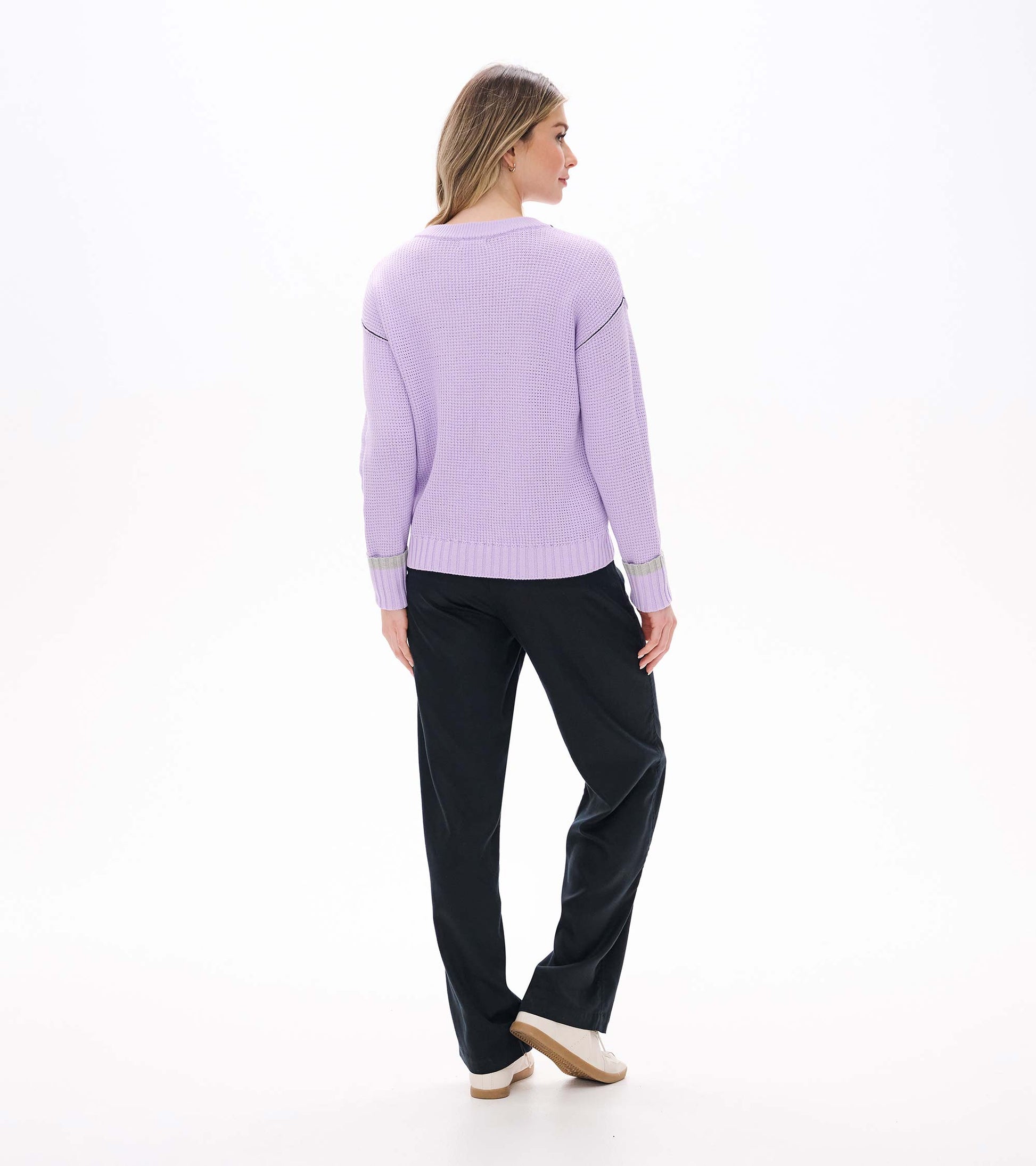 Back view of lilac waffle knit sweater with ribbed hem, drop shoulders, and contrast cuff bands