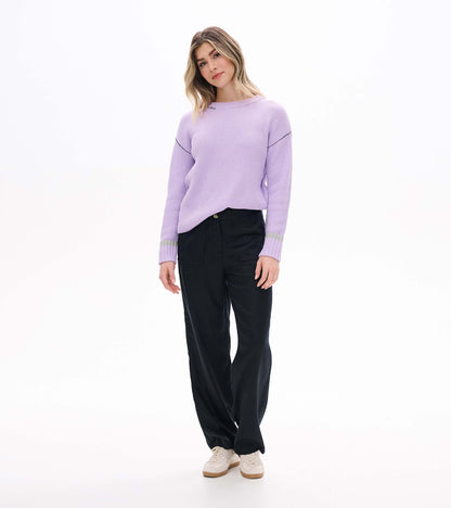 Front angled view of lilac waffle knit sweater with crew neck, drop shoulders, and contrast cuff bands