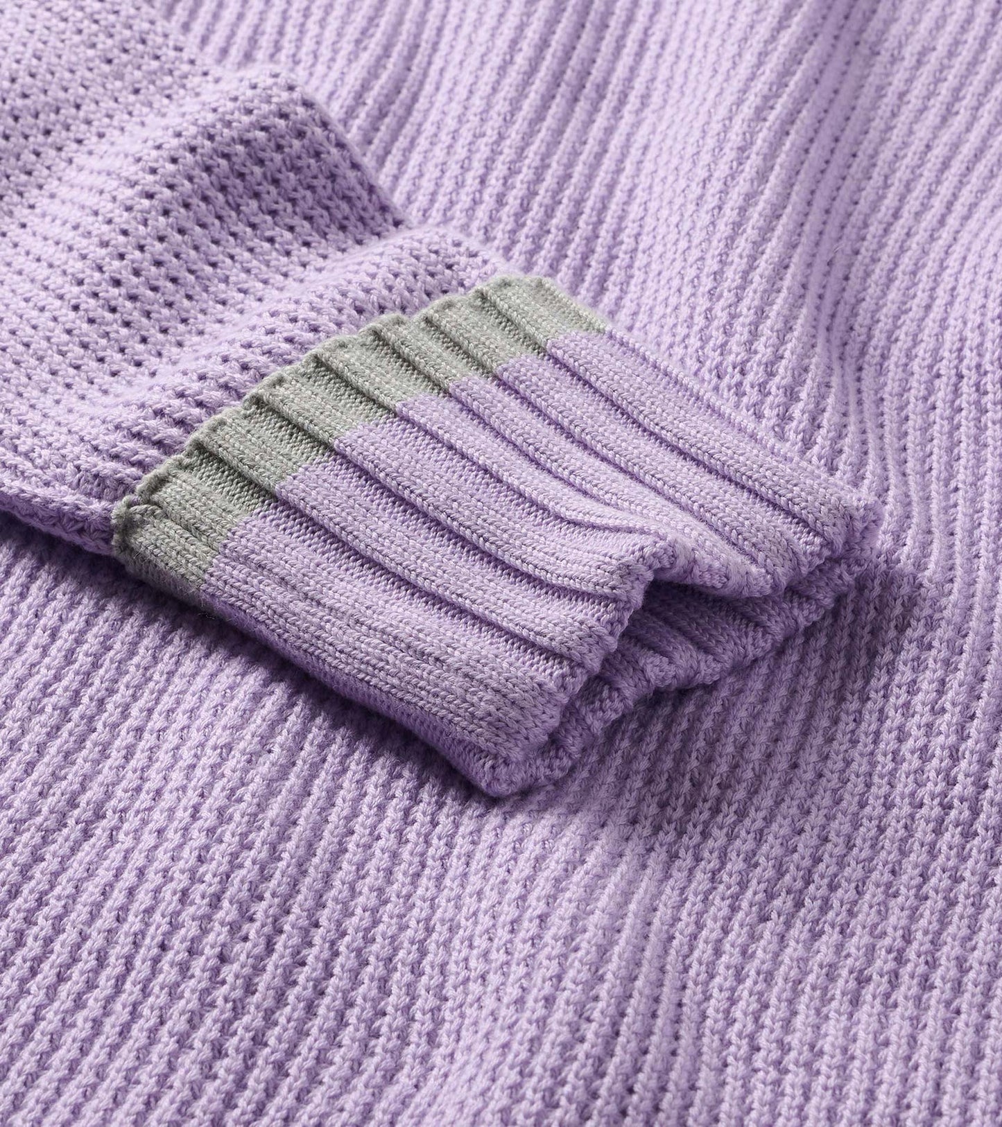 Close-up of lilac waffle knit sweater sleeve with ribbed cuff and gray trim