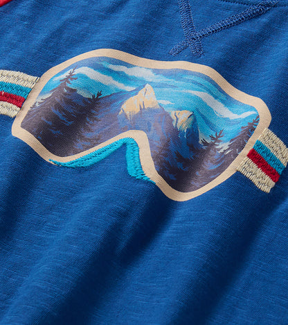 Close-up of ski goggles graphic with mountain landscape on blue T-shirt