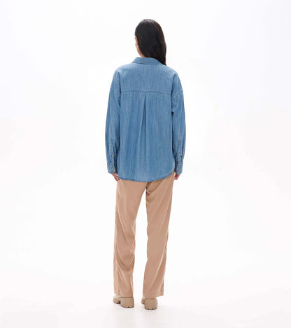 Back view of light blue wash relaxed button-down shirt with yoke seam and center back pleat