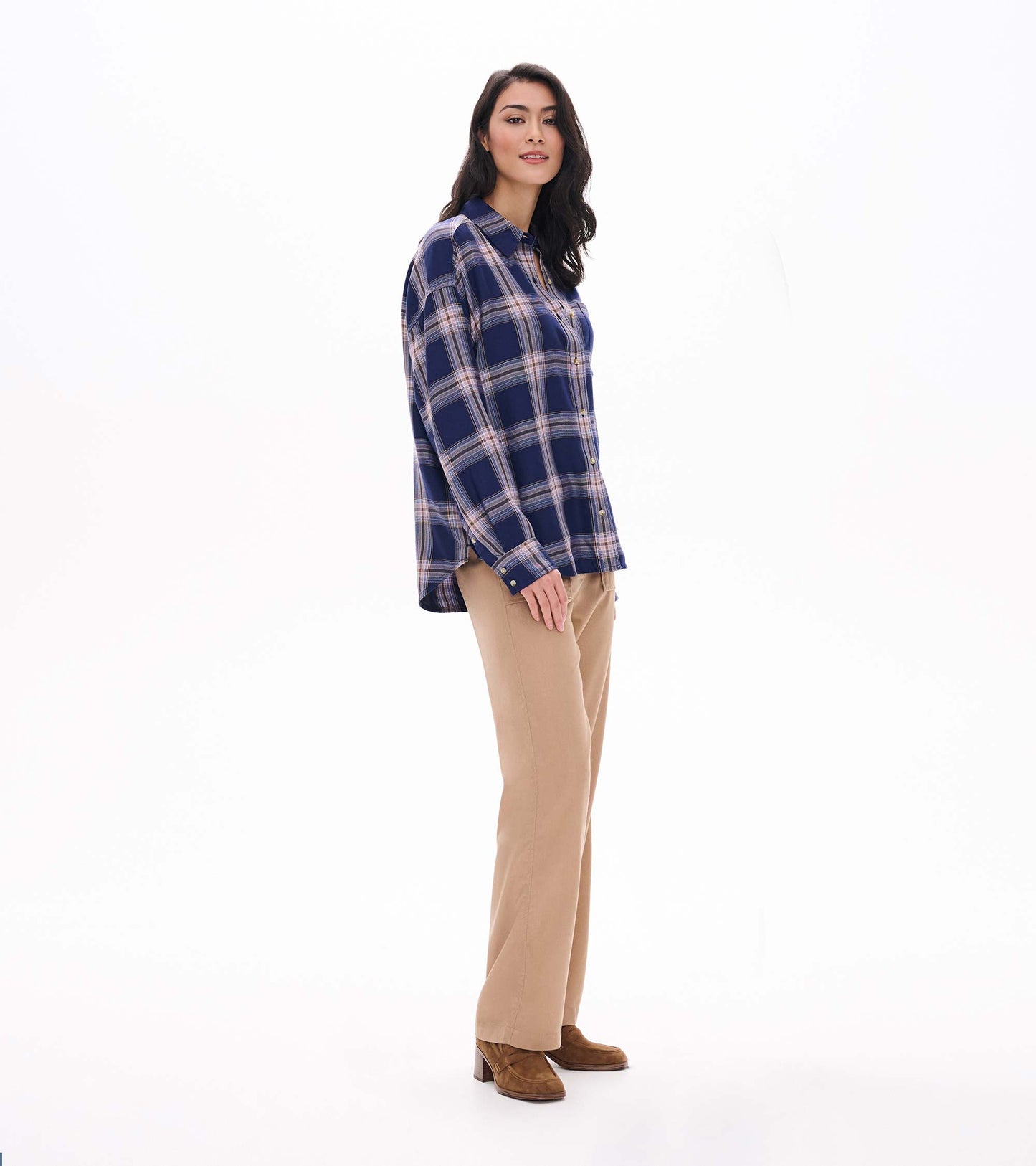 Side view of relaxed navy plaid button-down shirt with long sleeves and a longer back hem