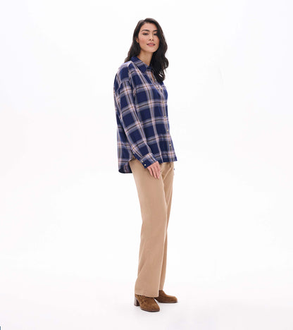 Side view of relaxed navy plaid button-down shirt with long sleeves and a longer back hem