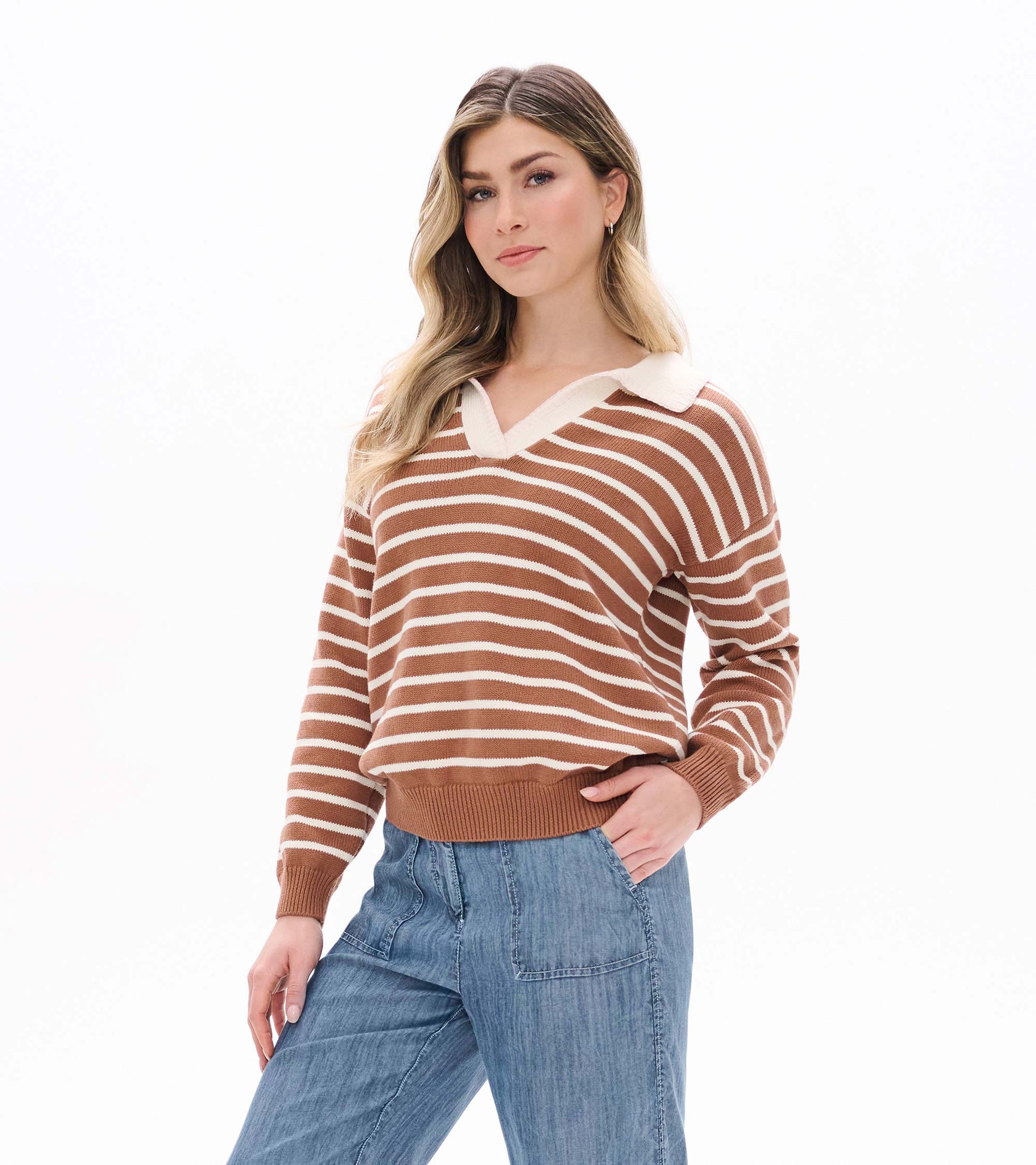 Model wearing camel and cream striped Johnny collar sweater with long sleeves and ribbed hem