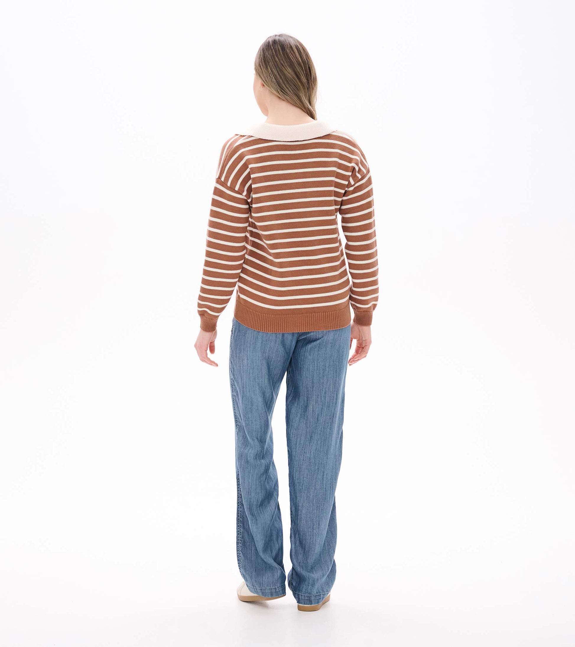 Back view of camel and cream striped sweater with cream collar and ribbed hem