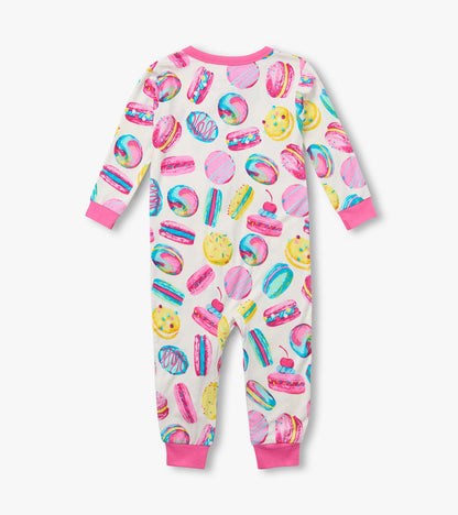 Back view of infant coverall with pink cuffs and colorful macaron and pastry print