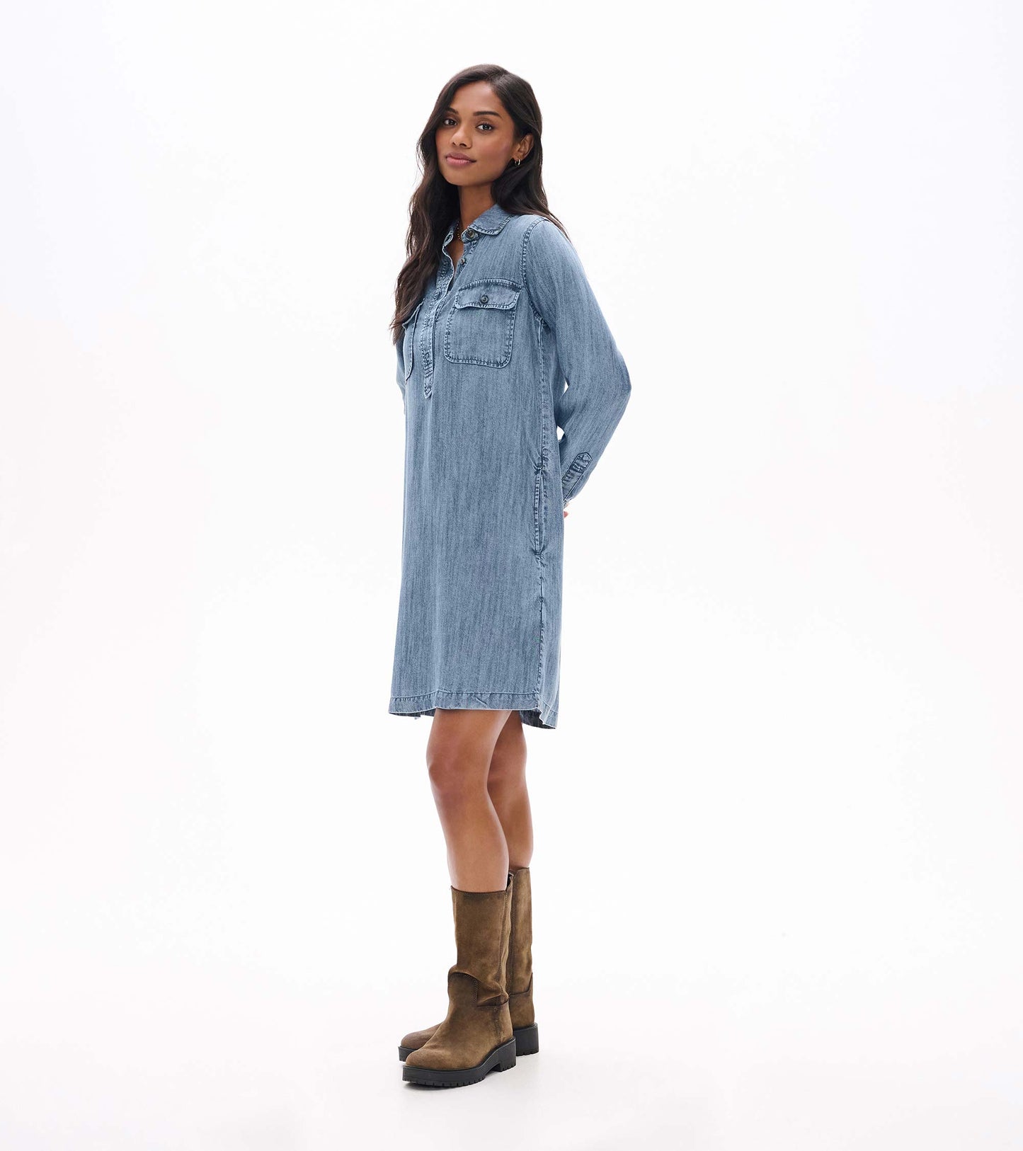 Side view of blue acid rinse popover dress with collar, long sleeves, chest pocket, and side pocket