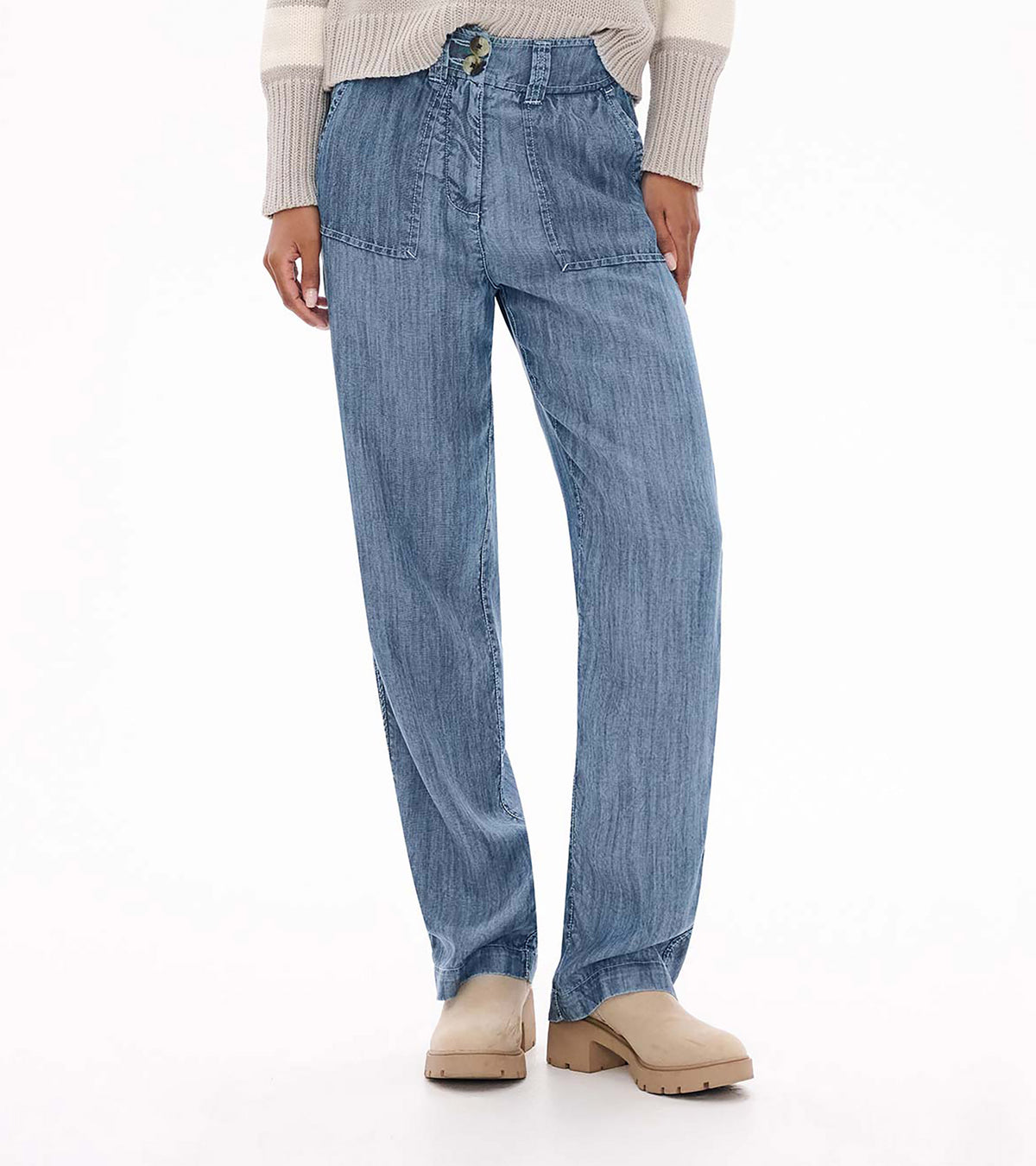 Front view of blue acid rinse wide leg pants with high waist, patch pockets and double-button closure