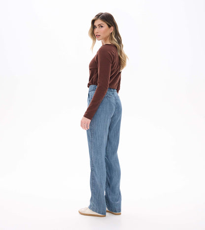 Back angled view of blue acid rinse wide leg pants with a high waist and full-length legs