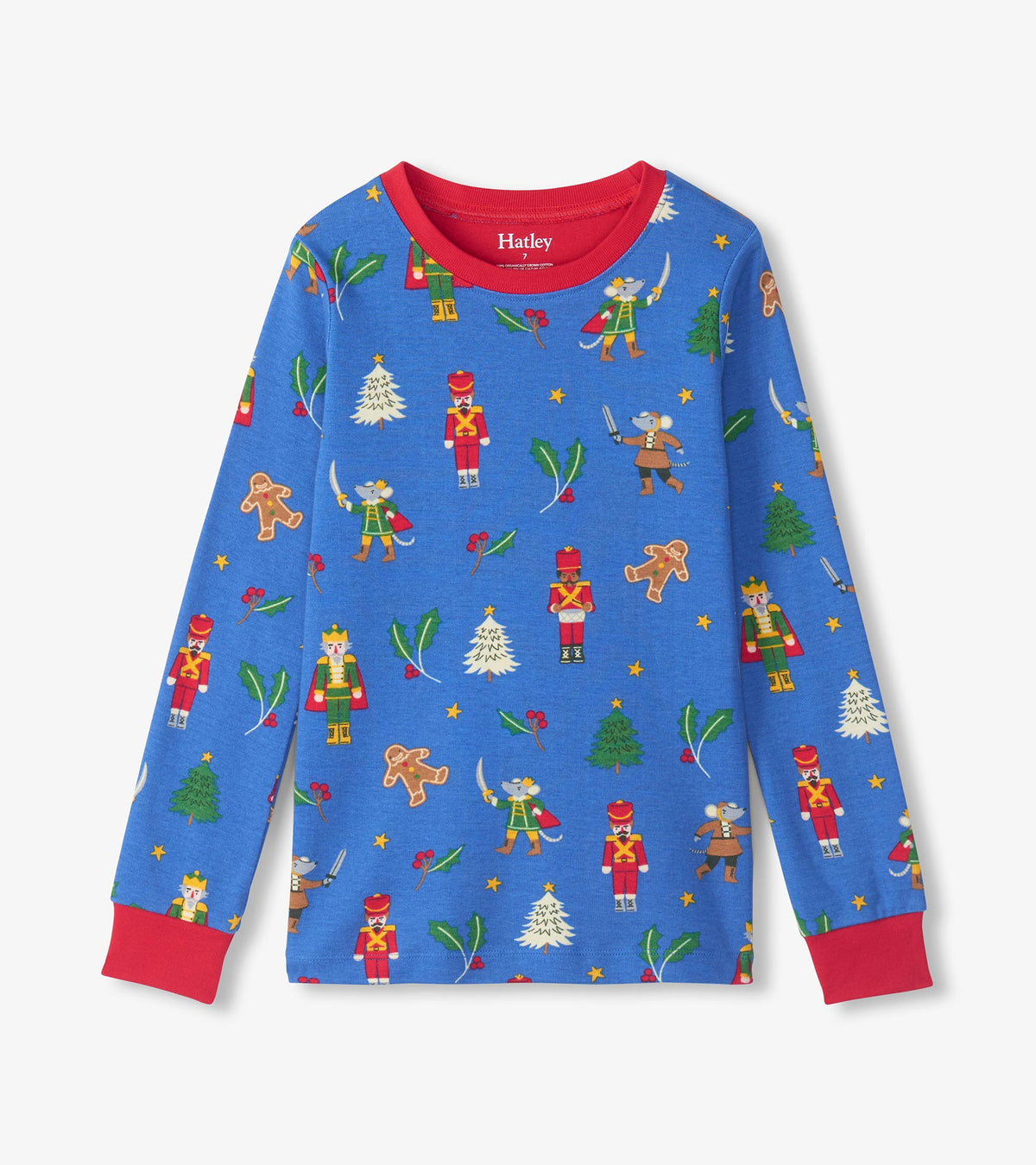 Blue long sleeve pajama top with red cuffs and collar, featuring nutcracker and holiday character print