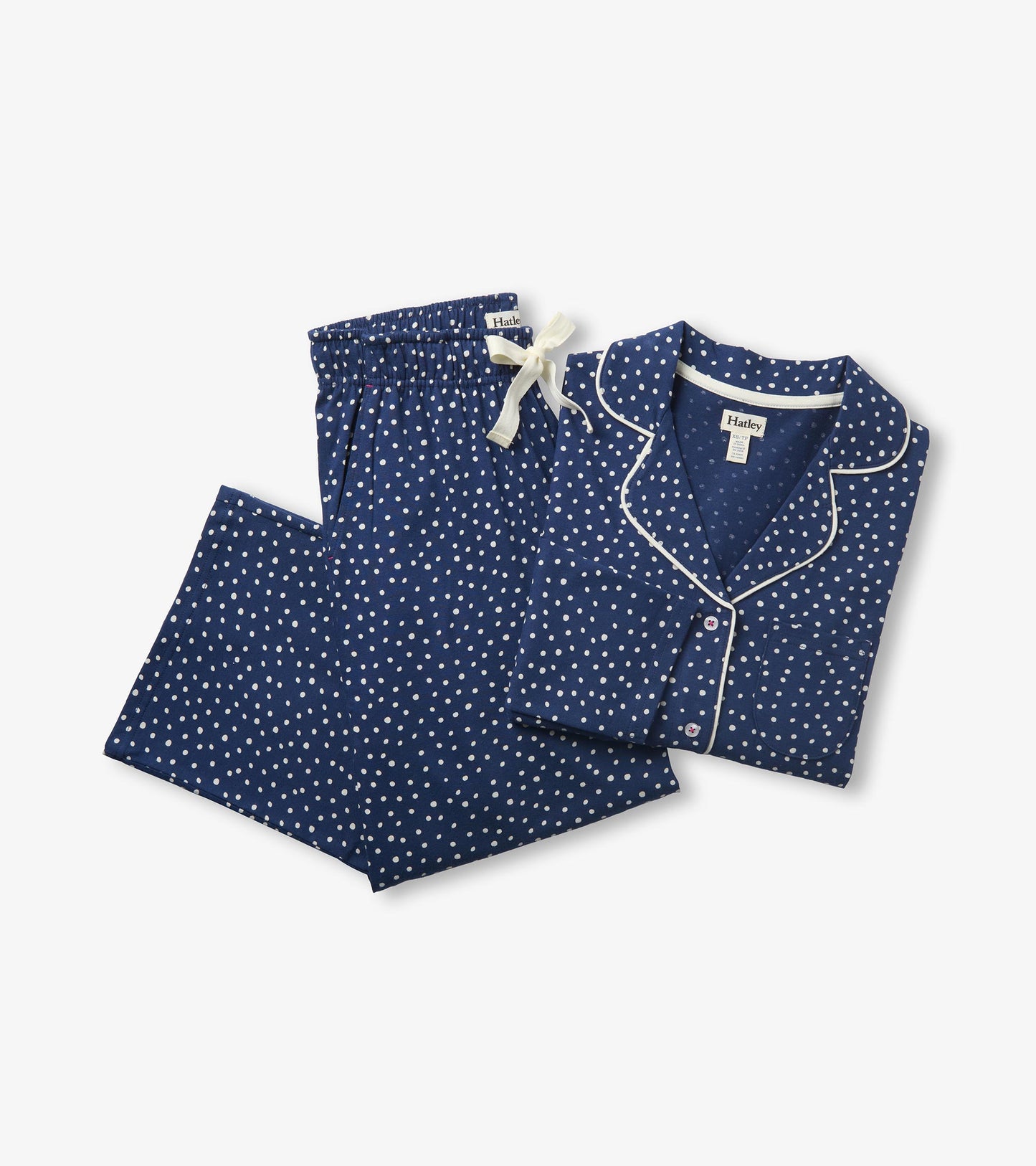 Blue polka dot pajama set with long sleeve button-front top and matching pants with white drawstring